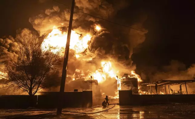 Firefighters extinguish a fire after a Russian attack on a residential neighborhood in Kharkiv, Ukraine Saturday, Feb. 10, 2024. (AP Photo/Yevhen Titov)