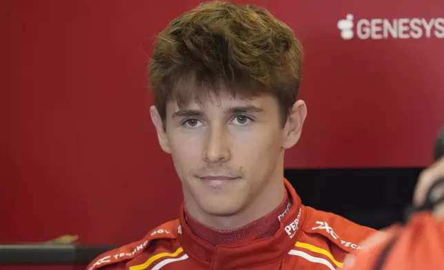 Ferrari driver Arthur Leclerc of Monaco stands in the garage before his debut free practice ahead of the Formula One Abu Dhabi Grand Prix at the Yas Marina Circuit in Abu Dhabi, UAE, Friday, Dec. 6, 2024. (AP Photo/Darko Bandic)