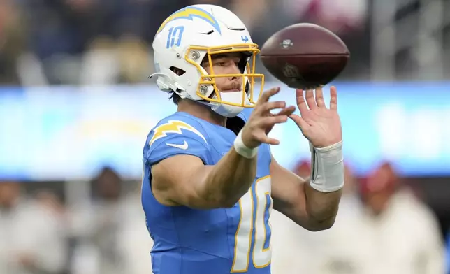 Los Angeles Chargers quarterback Justin Herbert (10) throws a pass during the first half of an NFL football game against the Tampa Bay Buccaneers, Sunday, Dec. 15, 2024, in Inglewood, Calif. (AP Photo/Eric Thayer)