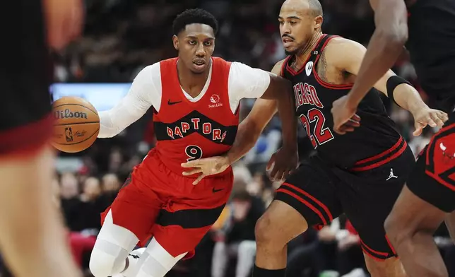 Toronto Raptors' RJ Barrett (9) protects the ball from Chicago Bulls' Talen Horton-Tucker (22) during second-half NBA basketball game action in Toronto, Monday, Dec. 16, 2024. (Frank Gunn/The Canadian Press via AP)