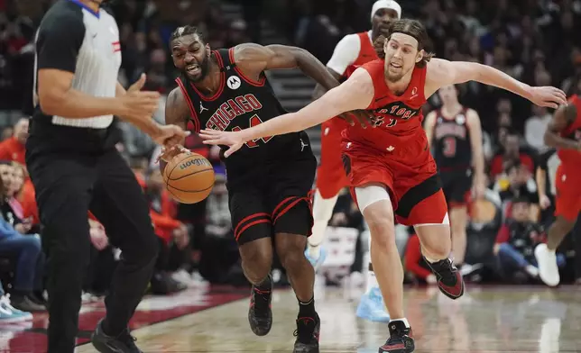 Chicago Bulls' Patrick Williams, second left, and Toronto Raptors' Kelly Olynyk (41) battle for the ball during the first half of an NBA basketball game in Toronto on Monday, Dec. 16, 2024. (Frank Gunn/The Canadian Press via AP)