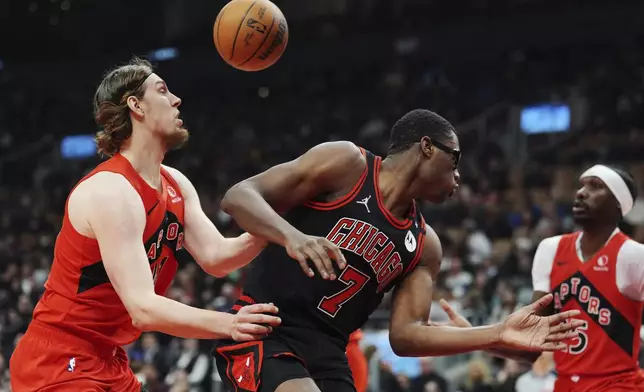 Chicago Bulls' Jalen Smith (7) is stripped of the ball by Toronto Raptors' Kelly Olynyk, left, during first-half NBA basketball game action in Toronto, Monday, Dec. 16, 2024. (Frank Gunn/The Canadian Press via AP)