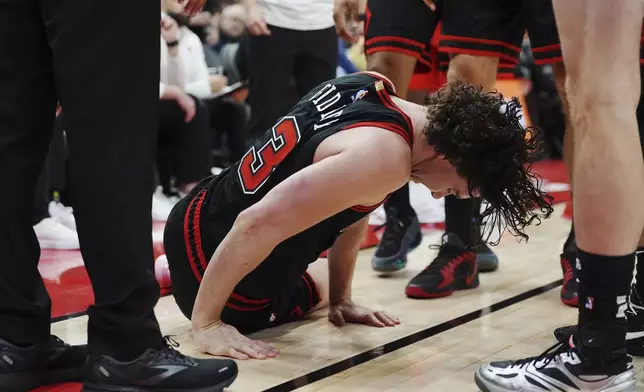 Chicago Bulls' Josh Giddey (3) reacts after falling during second-half NBA basketball game action against the Toronto Raptors in Toronto, Monday, Dec. 16, 2024. (Frank Gunn/The Canadian Press via AP)