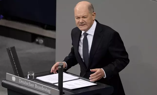 FILE - German Chancellor Olaf Scholz speaks during a plenary session at the German parliament Bundestag where he faces a vote of confidence, in Berlin, Dec. 16, 2024. (AP Photo/Markus Schreiber, File)