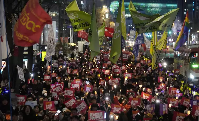 FILE - Protesters march to the presidential office after a candlelight vigil against South Korean President Yoon Suk Yeol in Seoul, South Korea, Dec. 5, 2024. (AP Photo/Ahn Young-joon, File)