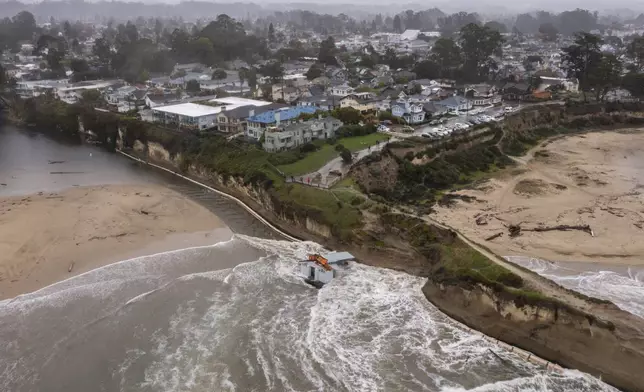 Remnants of a bathroom that fell off the wharf are seen at the mouth of the San Lorenzo River in Santa Cruz, Calif., Tuesday, Dec. 24, 2024. (AP Photo/Nic Coury)