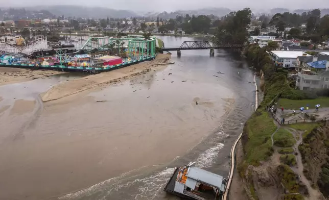 Remnants of a bathroom that fell off the wharf are seen at the mouth of the San Lorenzo River in Santa Cruz, Calif., Tuesday, Dec. 24, 2024. (AP Photo/Nic Coury)