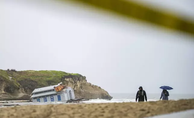 Remnants of a bathroom that fell off the wharf are seen at the mouth of the San Lorenzo River in Santa Cruz, Calif., Tuesday, Dec. 24, 2024. (AP Photo/Nic Coury)