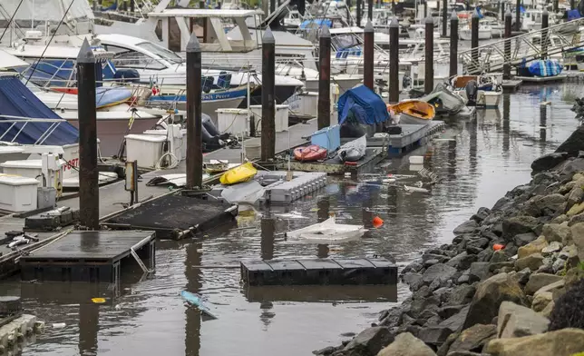 Trash and damaged boat parts float through Santa Cruz Harbor in Santa Cruz, Calif., Tuesday, Dec. 24, 2024. (AP Photo/Nic Coury)