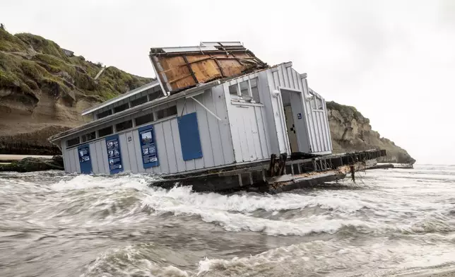 A section of the Santa Cruz Wharf that collapsed into the Pacific Ocean floats at a nearby beach amidst heavy surf in Santa Cruz, Calif., Tuesday, Dec. 24, 2024. (Stephen Lam/San Francisco Chronicle via AP)