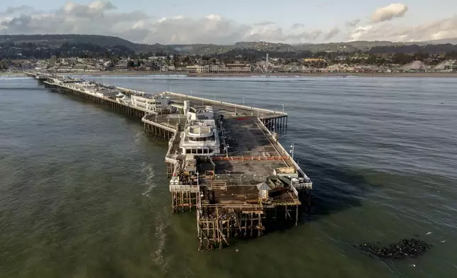 The damaged Santa Cruz Wharf is seen after a section of the pier fell into the ocean during high surf the previous day, in Santa Cruz, Calif., Tuesday, Dec. 24, 2024. (Stephen Lam/San Francisco Chronicle via AP)