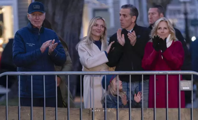 President Joe Biden accompanied by his family from left, Melissa, Hunter Biden, grandson Beau and First Lady Jill Biden, applauds during a Christmas tree lighting ceremony in downtown Nantucket Mass., Friday, Nov. 29, 2024. (AP Photo/Jose Luis Magana)