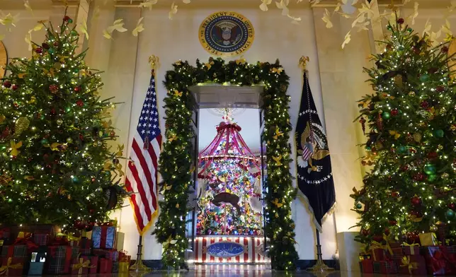 Trees in the Cross Hall frame the doorway to the Blue Room of the White House in Washington, as everything is decorated for the holidays, Monday, Dec. 2, 2024. (AP Photo/Susan Walsh)