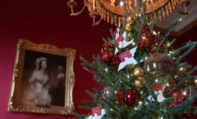 The Red Room of the White House in Washington, is decorated for the holidays, Monday, Dec. 2, 2024. (AP Photo/Susan Walsh)