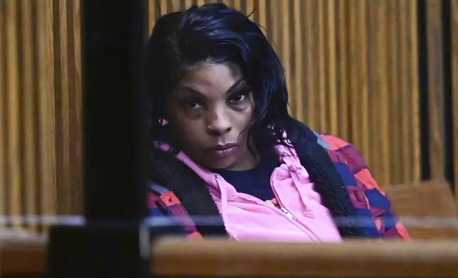 Fiona Allen fills out paperwork after being arraigned in Cuyahoga County Common Pleas Court, Tuesday, Dec. 3, 2024. Allen is accused of illegally voting in five different elections since 2020. Though Allen is a legal resident of the United States, prosecutors say she is not an American citizen. (AP Photo/David Dermer)