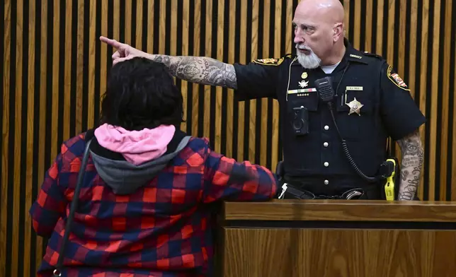 Fiona Allen received instructions from a Sheriffs deputy after being arraigned in Cuyahoga County Common Pleas Court,, Tuesday, Dec. 3, 2024. Allen is accused of illegally voting in five different elections since 2020. Though Allen is a legal resident of the United States, prosecutors say she is not an American citizen. (AP Photo/David Dermer)