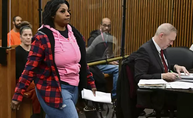 Fiona Allen walks toward the bench for her arraignment in Cuyahoga County Common Pleas Court, Tuesday, Dec. 3, 2024, in Cleveland. Allen is accused of illegally voting in five different elections since 2020. Though Allen is a legal resident of the United States, prosecutors say she is not an American citizen. (AP Photo/David Dermer)