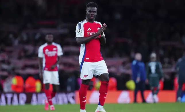 Arsenal's Saka claps hands to spectators after the end of the Champions League opening phase soccer match between Arsenal and Monaco, at the Emirates Stadium in London, Wednesday , Dec.11, 2024. Arsenal won 3-0.(AP Photo/Dave Shopland)