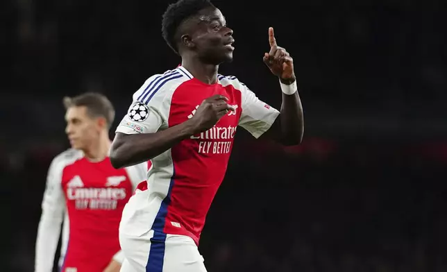 Arsenal's Bukayo Saka, celebrates after scoring his side's second goal during the Champions League opening phase soccer match between Arsenal and Monaco, at the Emirates Stadium in London, Wednesday , Dec.11, 2024. (AP Photo/Dave Shopland)