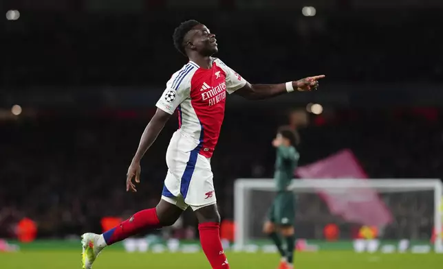 Arsenal's Bukayo Saka, celebrates after scoring his side's second goal during the Champions League opening phase soccer match between Arsenal and Monaco, at the Emirates Stadium in London, Wednesday , Dec.11, 2024. (AP Photo/Dave Shopland)