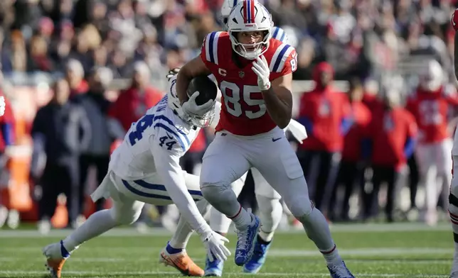 New England Patriots tight end Hunter Henry (85) carries the ball against Indianapolis Colts linebacker Zaire Franklin (44) during the first half of an NFL football game, Sunday, Dec. 1, 2024, in Foxborough, Mass. (AP Photo/Steven Senne)