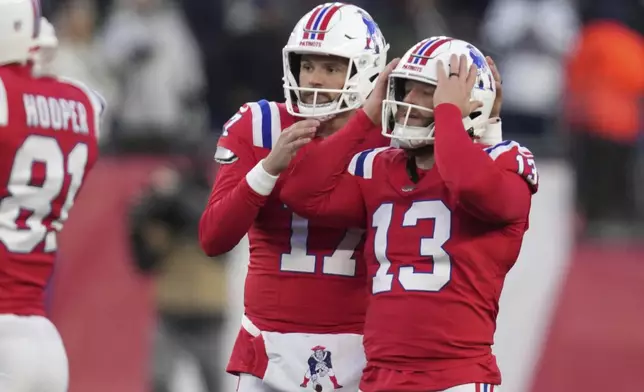 New England Patriots place-kicker Joey Slye (13) reacts beside punter Bryce Baringer (17) after missing a field goal-attempt during the second half of an NFL football game against the Indianapolis Colts, Sunday, Dec. 1, 2024, in Foxborough, Mass. (AP Photo/Charles Krupa)