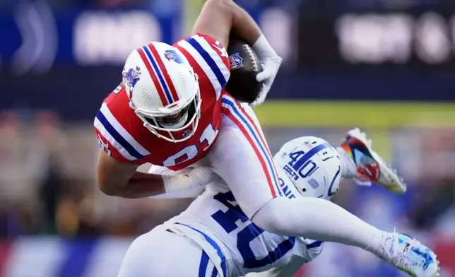 Indianapolis Colts cornerback Jaylon Jones (40) brings down New England Patriots tight end Austin Hooper (81) during the first half of an NFL football game, Sunday, Dec. 1, 2024, in Foxborough, Mass. (AP Photo/Steven Senne)