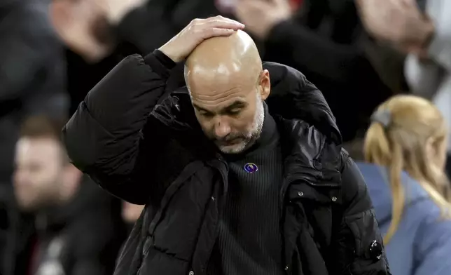 Manchester City's head coach Pep Guardiola reacts after Liverpool scored their second goal during the English Premier League soccer match between Liverpool and Manchester City at Anfield Stadium, Liverpool, England, Sunday Dec. 1, 2024. (AP Photo/Ian Hodgson)