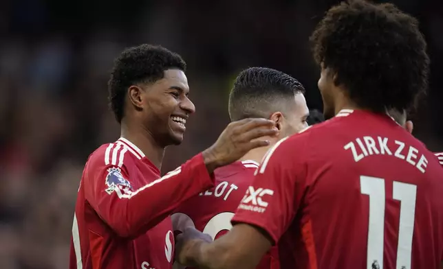 Manchester United's Marcus Rashford, left, celebrates with teammates after scoring during the English Premier League soccer match between Manchester United and Everton at the Old Trafford stadium in Manchester, England, Sunday, Dec. 1, 2024. (AP Photo/Dave Thompson)