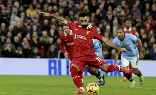 Liverpool's Mohamed Salah scores his side's second goal from the penalty spot during the English Premier League soccer match between Liverpool and Manchester City at Anfield Stadium, Liverpool, England, Sunday Dec. 1, 2024. (AP Photo/Ian Hodgson)