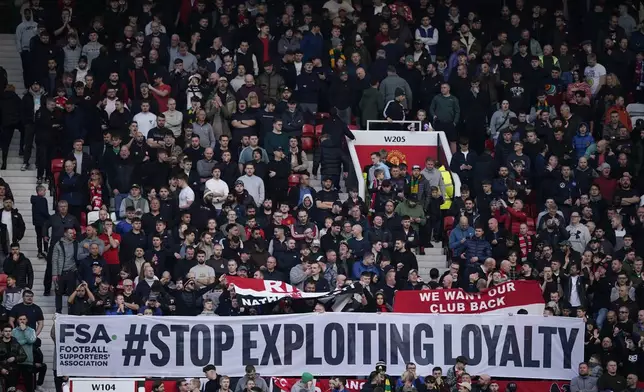 Manchester United's fans show a banner during the English Premier League soccer match between Manchester United and Everton at the Old Trafford stadium in Manchester, England, Sunday, Dec. 1, 2024. (AP Photo/Dave Thompson)