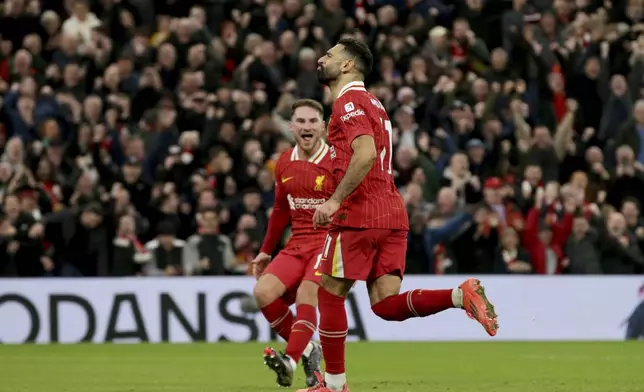 Liverpool's Mohamed Salah runs celebrating after scoring his side's second goal from the penalty spot during the English Premier League soccer match between Liverpool and Manchester City at Anfield Stadium, Liverpool, England, Sunday Dec. 1, 2024. (AP Photo/Ian Hodgson)