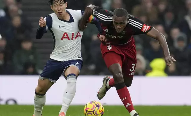 Tottenham Hotspur's Son Heung-Min, left, and Fulham's Issa Diop in action during the English Premier League soccer match at the Tottenham Hotspur Stadium, London, Sunday Dec. 1, 2024. (Ben Whitley/PA via AP)