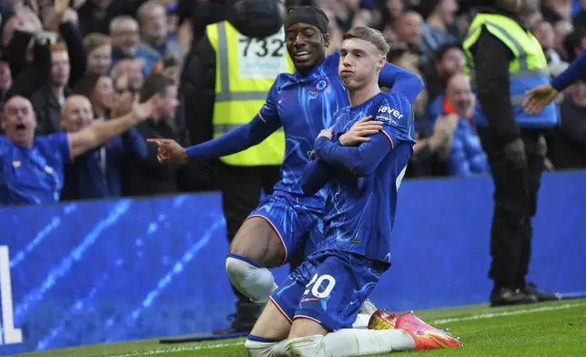 Chelsea's Cole Palmer, right, celebrates after scoring his side's third goal during the English Premier League soccer match between Chelsea and Aston Villa at the Stamford Bridge stadium in London, Sunday, Dec. 1, 2024. (AP Photo/Kirsty Wigglesworth)