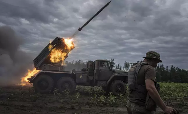 FILE - Ukrainian forces shoot toward Russian positions at the front line in the Kharkiv region of Ukraine, on Aug. 2, 2022. (AP Photo/Evgeniy Maloletka, File)