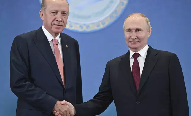 FILE - Russian President Vladimir Putin, right, and Turkish President Recep Tayyip Erdogan shake hands as they pose for photos during a meeting on the sidelines of the Shanghai Cooperation Organization summit in Astana, Kazakhstan, on July 3, 2024. (Sergey Guneyev, Sputnik, Kremlin Pool Photo via AP, File)