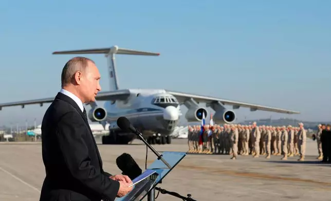 FILE - Russian President Vladimir Putin addresses troops at the Hemeimeem air base in Syria on Dec. 12, 2017. (Mikhail Klimentyev, Sputnik, Kremlin Pool Photo via AP, File)