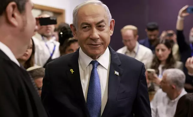 Israeli Prime Minister Benjamin Netanyahu arrives at the district court in Tel Aviv for his long-running trial for alleged corruption, in Tel Aviv, Israel, Tuesday, Dec. 10, 2024. (Menahem Kahana/Pool Photo via AP)