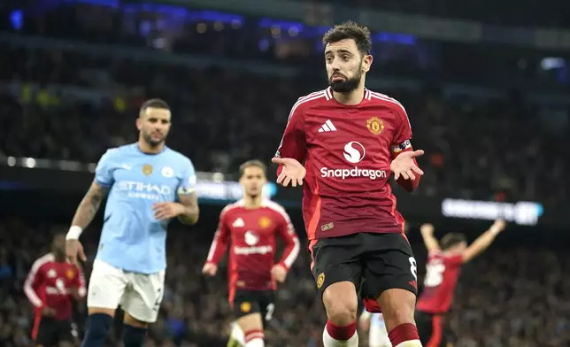 Manchester United's Bruno Fernandes celebrates after scoring his side's second goal during the English Premier League soccer match between Manchester City and Manchester United at the Etihad Stadium in Manchester, Sunday, Dec. 15, 2024. (AP Photo/Dave Thompson)