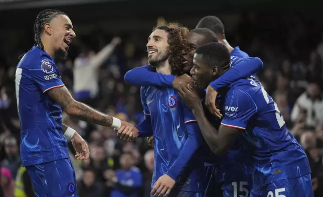 Chelsea's Marc Cucurella, second left, celebrates with teammates after scoring the opening goal of the game during the English Premier League soccer match between Chelsea and Brentford at Stamford Bridge in London, Sunday, Dec. 15, 2024. (AP Photo/Kin Cheung)