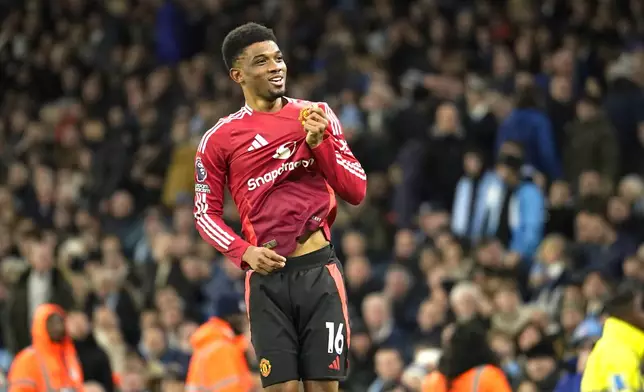 Manchester United's Amad Diallo celebrates after scoring his side's second goal during the English Premier League soccer match between Manchester City and Manchester United at the Etihad Stadium in Manchester, Sunday, Dec. 15, 2024. (AP Photo/Dave Thompson)