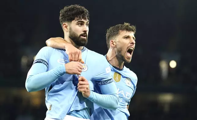 Manchester City's Josko Gvardiol, left, celebrates after scoring his side's opening goal during the English Premier League soccer match between Manchester City and Manchester United at the Etihad Stadium in Manchester, Sunday, Dec. 15, 2024. (AP Photo/Dave Thompson)