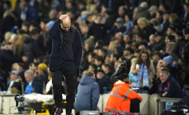 Manchester City's head coach Pep Guardiola reacts during the English Premier League soccer match between Manchester City and Manchester United at the Etihad Stadium in Manchester, Sunday, Dec. 15, 2024. (AP Photo/Dave Thompson)