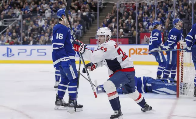 Washington Capitals center Connor McMichael (24) celebrates his goal against the Toronto Maple Leafs during the third period of an NHL hockey game, Friday, Dec. 6, 2024 in Toronto. (Cole Burston/The Canadian Press via AP)