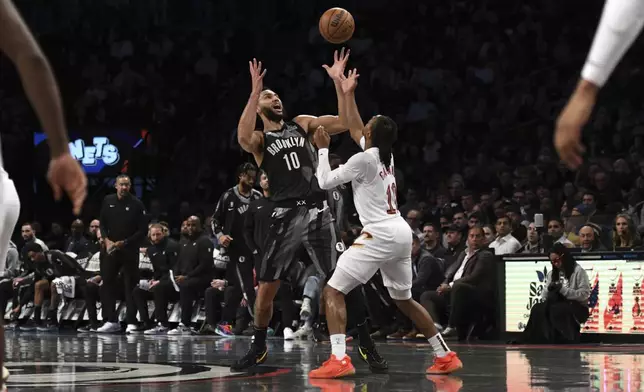 Cleveland Cavaliers' Darius Garland, right, knocks the ball away from Brooklyn Nets' Ben Simmons, left, during the first half of an NBA basketball game Monday, Dec. 16, 2024, in New York. (AP Photo/Pamela Smith)