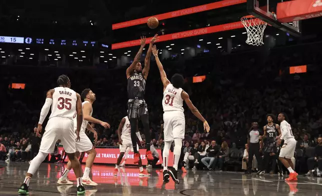 Brooklyn Nets' Nic Claxton shoots the ball during the first half of an NBA basketball game against the Cleveland Cavaliers Monday, Dec. 16, 2024, in New York. (AP Photo/Pamela Smith)