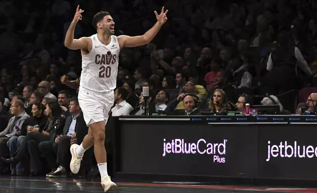 Cleveland Cavaliers' Georges Niang reacts after Caris LeVert, not pictured, scored during the first half of an NBA basketball game against the Brooklyn Nets Monday, Dec. 16, 2024, in New York. (AP Photo/Pamela Smith)