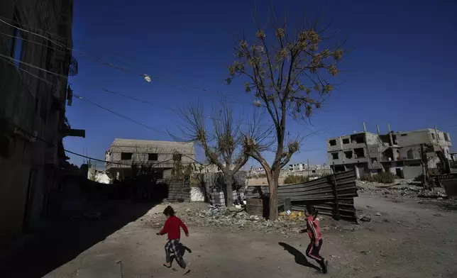 Syrian girls plays at an alley that was hit by the sarin struck during a 2013 chemical weapons attack that was blamed on then President Bashar Assad's forces, in Zamalka neighbourhood, on the outskirts of Damascus, Syria, Wednesday, Dec. 25, 2024. (AP Photo/Hussein Malla)