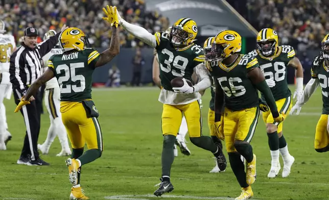 Green Bay Packers safety Zayne Anderson (39) celebrates his interception during the second half of an NFL football game against the New Orleans Saints, Monday, Dec. 23, 2024, in Green Bay, Wis. (AP Photo/Mike Roemer)