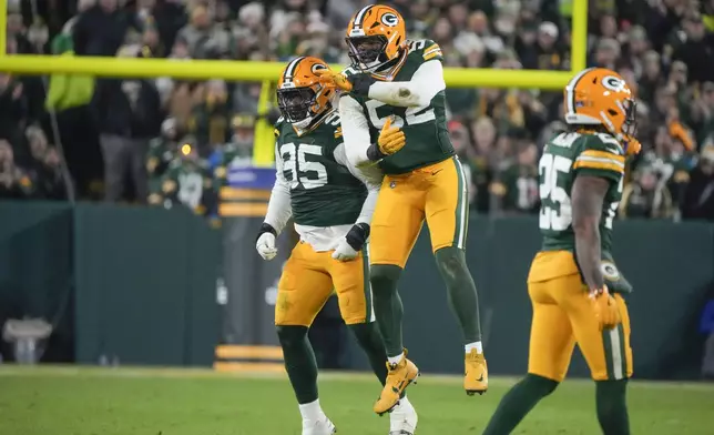 Green Bay Packers defensive tackle Devonte Wyatt (95) celebrates his sack with defensive end Rashan Gary (52) during the first half of an NFL football game, Monday, Dec. 23, 2024, in Green Bay, Wis. (AP Photo/Morry Gash)